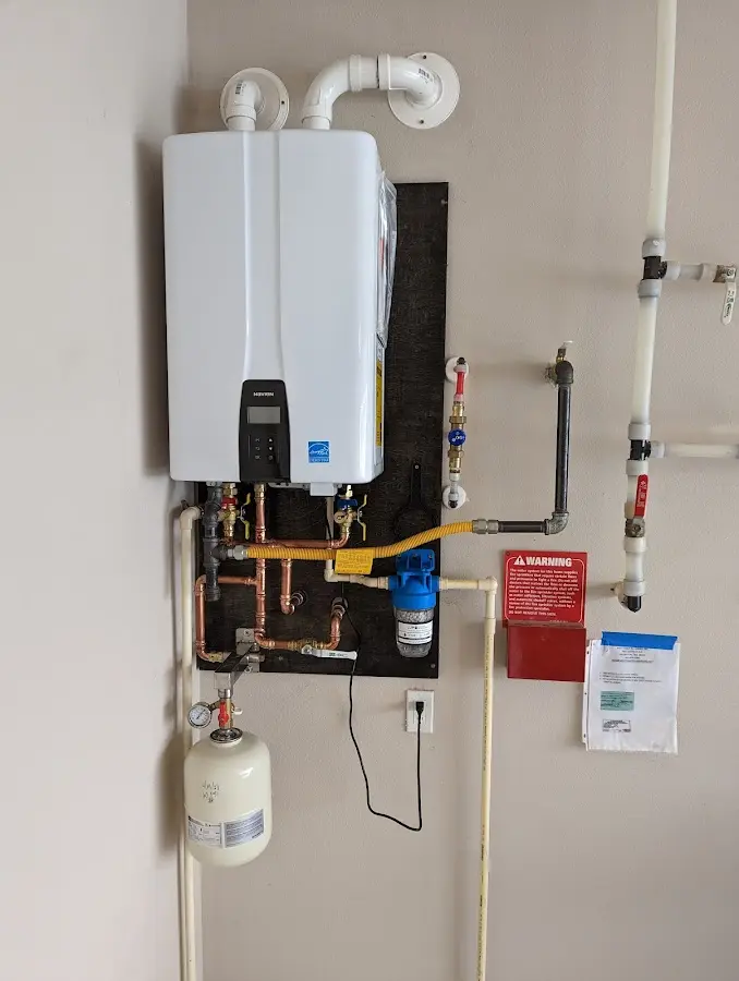 Professional plumber installing copper piping in a Marysville home